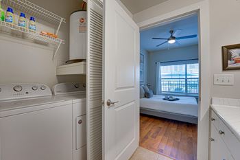 A small laundry room with a washer and dryer.